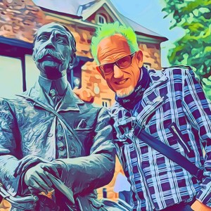 Stylised photo of Dave the Punk with bright green hair, sunglasses and a checked shirt, standing beside a bronze statue.